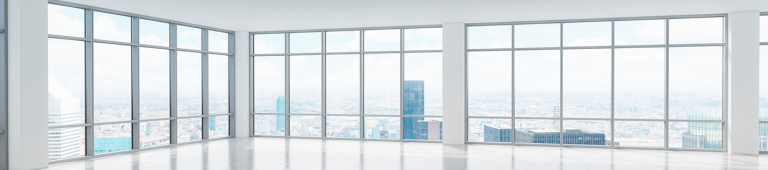 Empty corner office with floor-to-ceiling windows