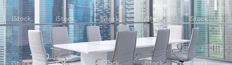 Modern boardroom with white chairs and city view
