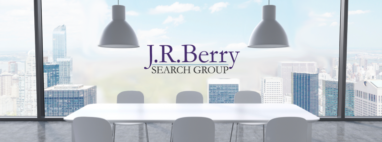 Boardroom table under pendant lights with logo
