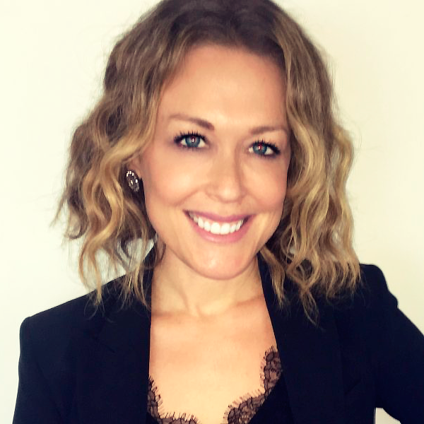 Smiling woman with wavy blonde hair close-up